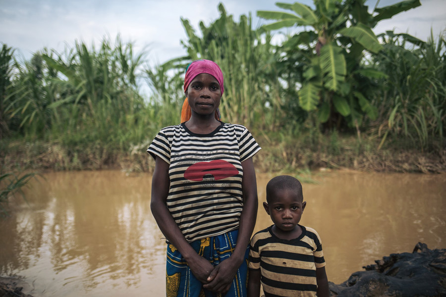 Rizini fetches water to the contaminated river in Malinde village three times a day with her four-year old son, Jack. 