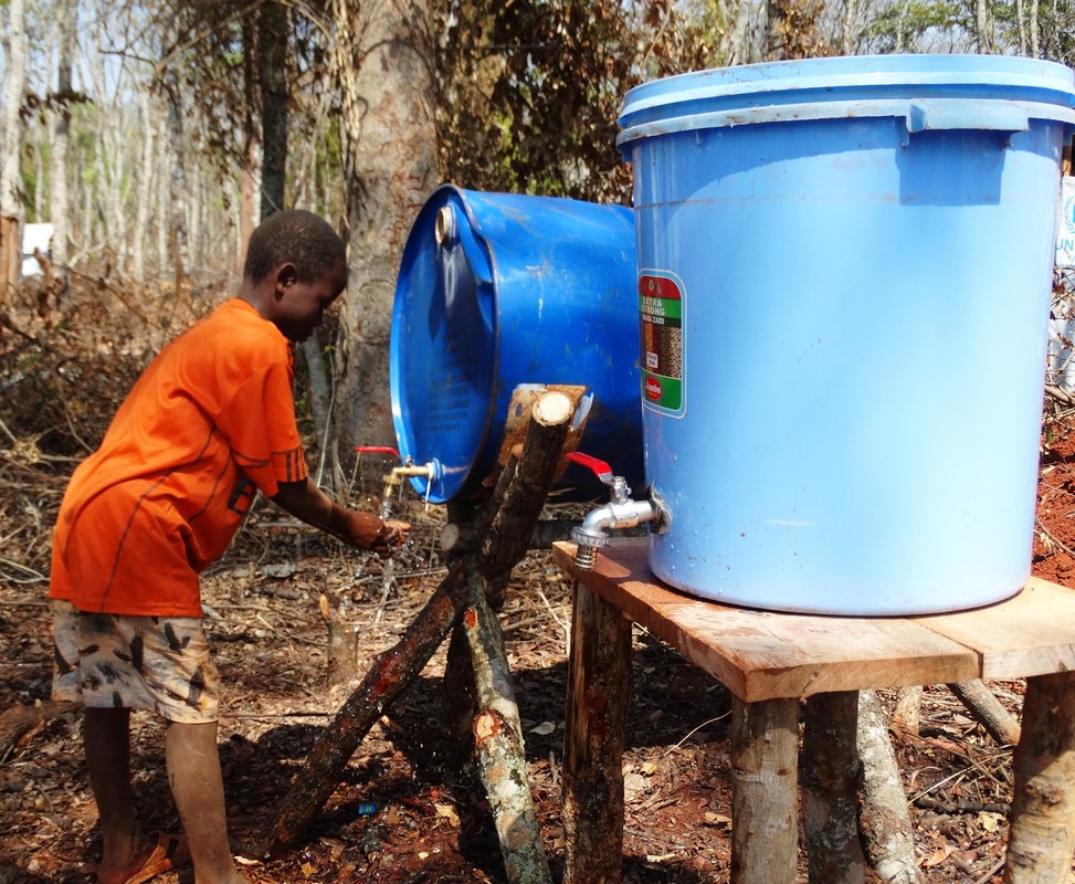 A boy washes his hands at an Oxfam hygiene station, Nduta camp, Tanzania.