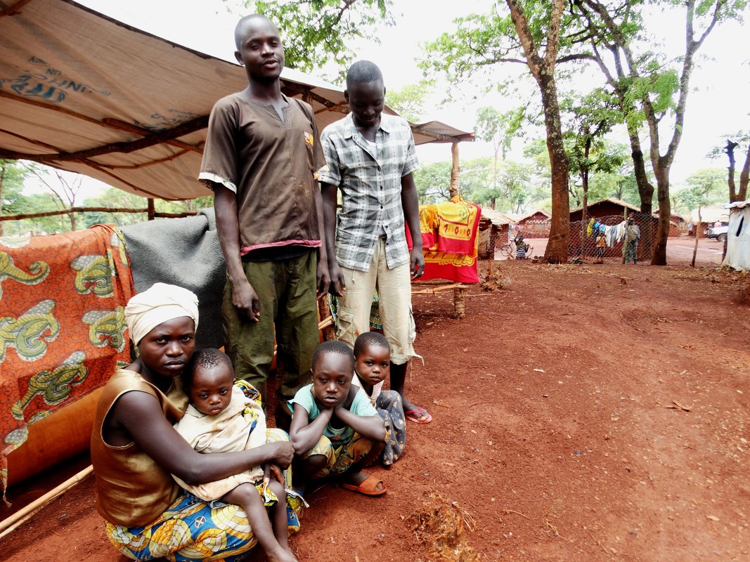 A Burundian refugee family wait to move camps in Tanzania