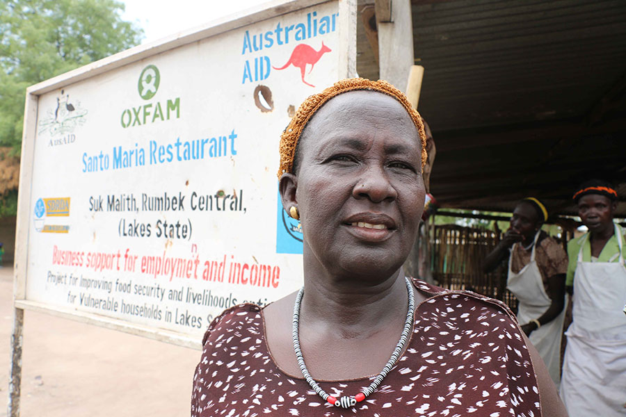 A business woman stands outside her restaurant in South Sudan