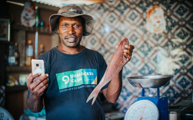 A fish vendor in Vanuatu participating in the UnBlocked Cash project