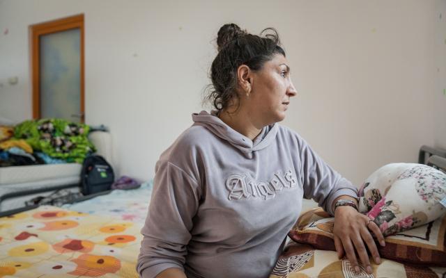 Olga, a 34-year-old Ukrainian refugee from Vinnytsia in her shared room at the Center for Humanitarian and Social Aid in Romania.