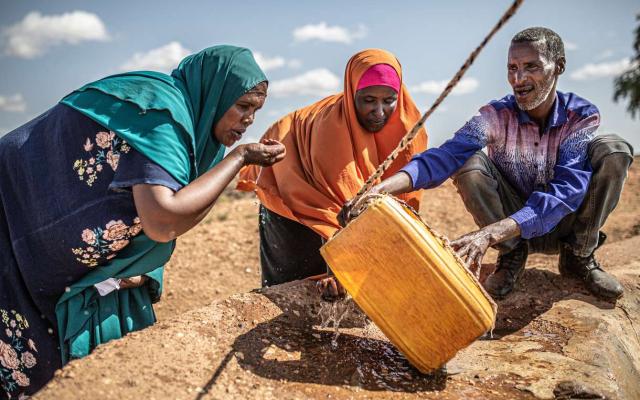 Villagers near Gilo, in Ethiopia’s southern Somali region, draw water from a reservoir. The area is experiencing frequent climate-induced drought. Pablo Tosco / Oxfam Intermón