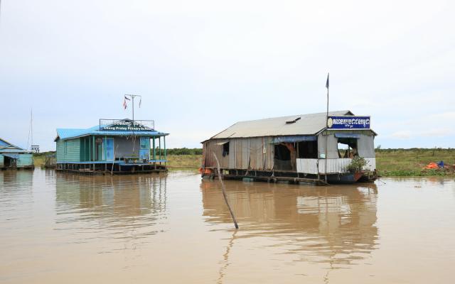 The schools and other structures float alongside the homes. Here, a primary school is seen next to several other buildings, all adapted to life on the water.