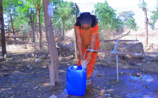 Ms. Birey Yohans Werede, 40, fills a jerrycan at a water point near her shelter in Hitsats, Tigray. (Photo: Oxfam)