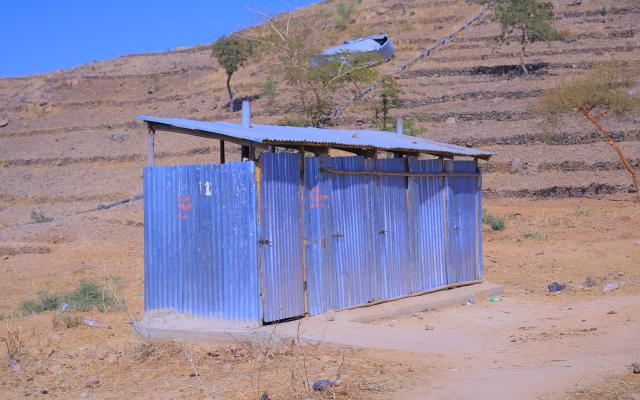 Oxfam repaired this latrine in Hitsats, helping reduce open defecation and improve sanitation for families living in the site. (Photo: Oxfam)