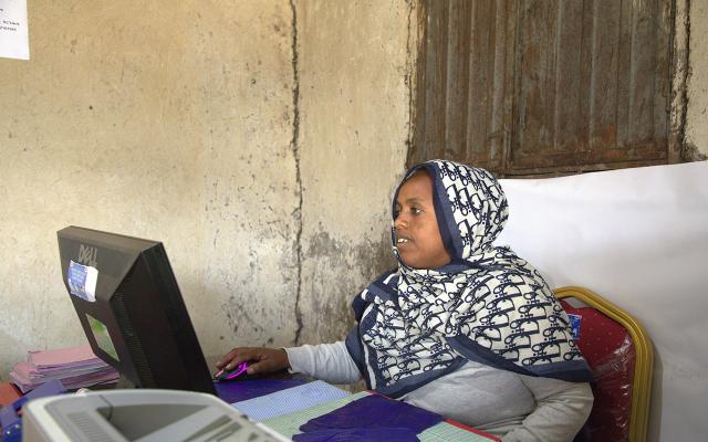 Berehane Eshete (36), manager of Andenet (Cheki Andinet) Dairy Cooperative Association, updates records and coordinates daily operations in Debre Birhan