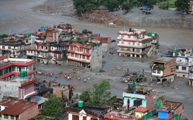 The morning scene in Devighat, Nuwakot, reveals the aftermath of severe flooding. Residents are desperately trying to salvage usable belongings from their inundated homes.