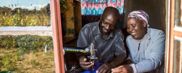 Opheus Dube teaches tailoring skills to his wife Paulina Sibanda in their home in Zvishevane region, Zimbabwe. Credit: Aurelie Marrier d'Unienville / Oxfam Opheus Dube teaches tailoring skills to his wife Paulina Sibanda in their home in Zvishevane region, Zimbabwe. Credit: Aurelie Marrier d'Unienville / Oxfam