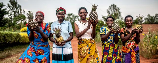 Tuzamurane cooperative members stand outside the cooperative centre in Eastern Rwanda, Kirehe District. 