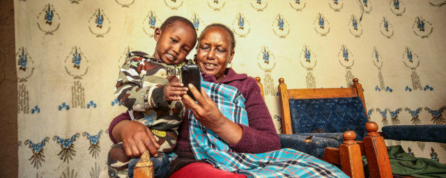 Damaris Lesiamito and her grandchild have a light moment at their home in Maralal.