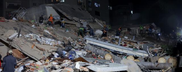 People and rescuers work on the debris from the Rita building after a magnitude 7.2 earthquake struck Venezuela and other regions in the Caribbean on June 24, 2026. 