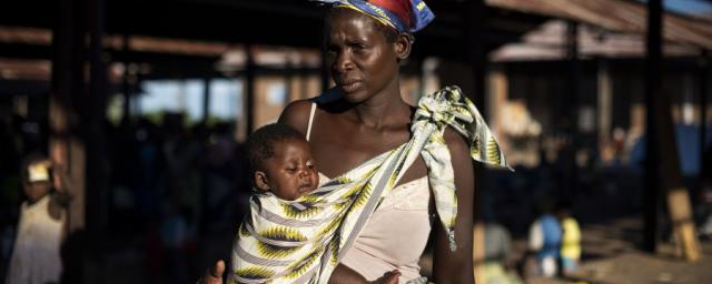 Malita, 35, stands in the Bangula camp, southern Malawi, when she found refuge after Cyclone Idai devastated her village in Mozambique. She had to stay two days in a tree with her three children before they were rescued. Photo: Philip Hatcher-Moore/Oxfam Malita, 35, stands in the Bangula camp, southern Malawi, when she found refuge after Cyclone Idai devastated her village in Mozambique. She had to stay two days in a tree with her three children before they were rescued. Photo: Philip Hatcher-Moore/Oxfam