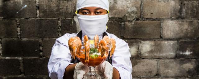  Melati, 18,  worked in an Indonesian shrimp factory. She was expected to peel 600 shrimps an hour. When cleaning the conveyor belt with a chlorine mixture, she burned her hands because she was not given the proper safety equipment. Photo: Adrian Mulya.