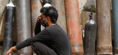 A man waits outside a factory to get his oxygen cylinder refilled, amidst the spread of the coronavirus disease (COVID-19) in New Delhi, India, April 28, 2021.