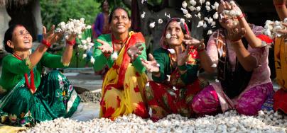 Women tossing garlic crops in a fun and spirited way.