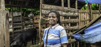 Marie N'simire, mother of two living in Tshazi, trader and farmer participating in the Oxfam BMZ project having received a pig, seeds, and agricultural tools. 