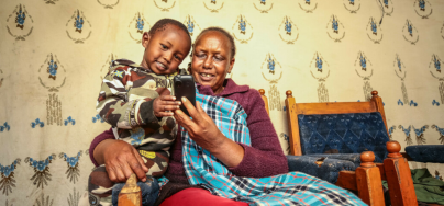Damaris Lesiamito and her grandchild have a light moment at their home in Maralal.