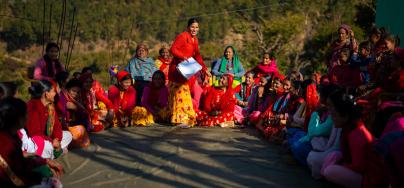 Pramila Bhul speaking to members of a Women’s Cooperative during its annual meeting.