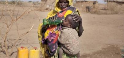 Fathima gives her son a drink of clean water, provided by Oxfam , Ethiopia Fathima gives her son a drink of clean water, provided by Oxfam , Ethiopia