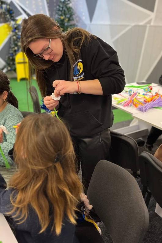 Nataliia helping children during a master class at "Meeting Place." Photo courtesy of United With Love to Children